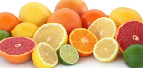 Citrus fruit collection with ruby red and yellow grapefruit, orange, lime and  lemons, whole and in halves, isolated over white background.