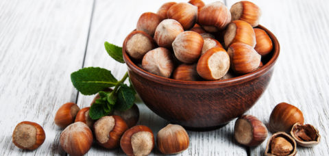 Bowl with hazelnuts on a old wooden table